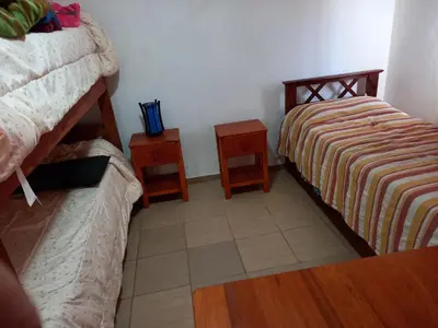 a bedroom with two beds and two night stands at Cabañas Dayma in Trapiche