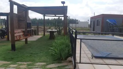 a backyard with a bird cage and a fence at Cabañas Dayma in Trapiche