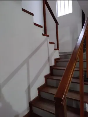 a staircase with wooden railings and a stair case at Casa Villa Naturaleza in Villa Rumipal