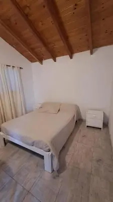 a bedroom with a bed and a wooden ceiling at Casa Villa Naturaleza in Villa Rumipal