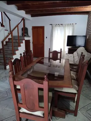 a dining room with a table and chairs and a couch at Casa Villa Naturaleza in Villa Rumipal