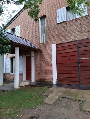 a red brick house with a red garage at Casa Villa Naturaleza in Villa Rumipal
