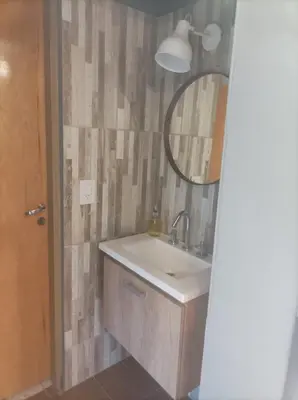 a bathroom with a sink and a mirror at Torito's House 3 in Tanti
