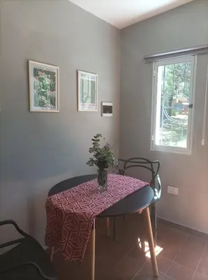 a table with a vase on it in a room at Torito's House 3 in Tanti