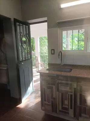 a kitchen with a door leading to a patio at Torito's House 3 in Tanti
