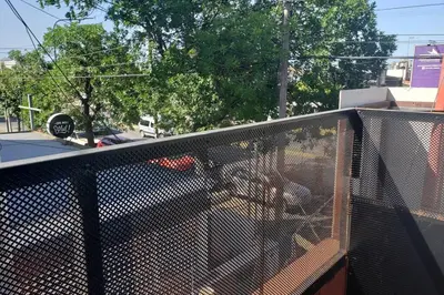 a chain link fence next to a street at Amplio Dpto s/Av Rafael Nuñez - cerro de las rosas in Cordoba
