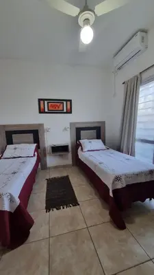 two beds in a room with white walls at Amplio Dpto s/Av Rafael Nuñez - cerro de las rosas in Cordoba