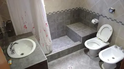 a bathroom with a toilet and a sink and a shower at Casas villa suiza con terraza in Villa Carlos Paz