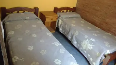 two beds sitting next to each other in a room at Casas villa suiza con terraza in Villa Carlos Paz