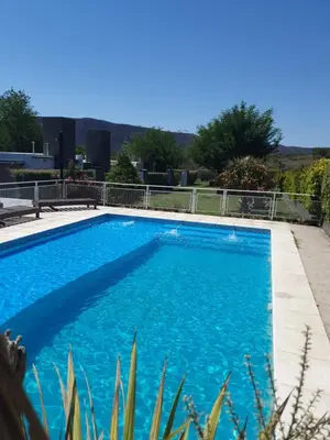 a large blue swimming pool with blue water at Aparts serranos in San Antonio de Arredondo