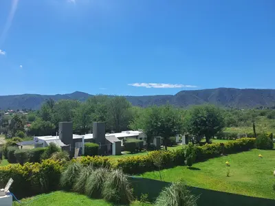 a view of a house with mountains in the background at Aparts serranos in San Antonio de Arredondo