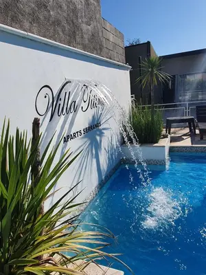 a sign on the side of a building with a swimming pool at Aparts serranos in San Antonio de Arredondo