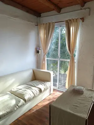 a living room with a couch and a window at Cabaña 