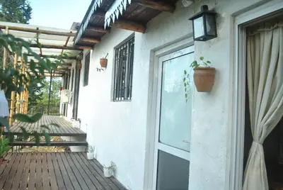 a porch of a house with a glass door at Cabaña 