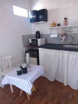 a small kitchen with a table and a sink at Cabaña 