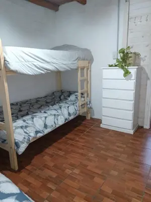 a bedroom with a bunk bed and a dresser at Cabaña 