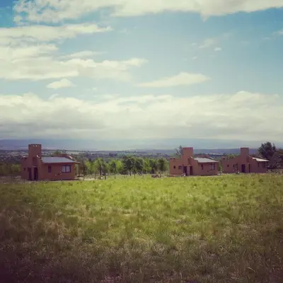 an empty field with houses in the middle of a field at Pequeña Polonia-Lodge & Cabañas in Los Reartes