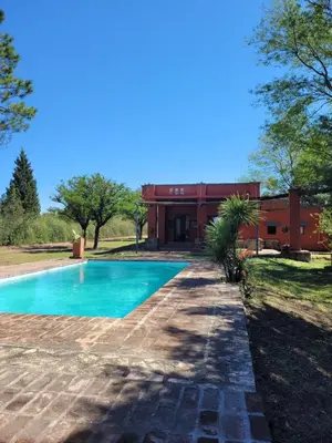 a swimming pool in front of a building at Casona de campo in Santa María