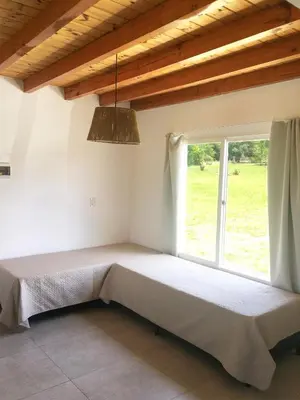 a bed in a room with a window at Cabañas Sonnenblumen in Potrero de Garay
