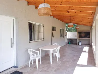 a table and chairs on a patio with a ceiling at Cabañas Sonnenblumen in Potrero de Garay
