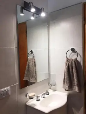 a bathroom with a sink and a mirror at Cabañas Sonnenblumen in Potrero de Garay