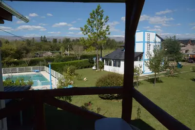 a view from a window of a yard with a pool at Aguila Blanca in Mina Clavero