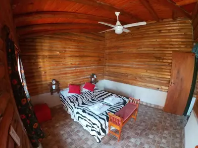 a bedroom with a bed and a ceiling fan at Aguila Blanca in Mina Clavero