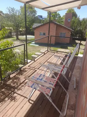 a deck with a lounge chair on a porch at Aguila Blanca in Mina Clavero