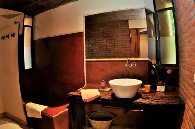 a bathroom with a sink and a brick wall at Cuatrovientos Hostería in San Javier