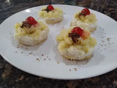 a white plate with four mini desserts on it at 7 esencias in Villa Yacanto