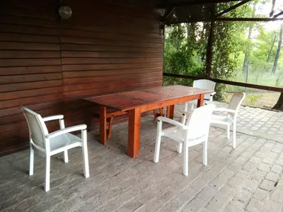 a wooden table and chairs on a patio at Cabañas UN LUGAR in Villa General Belgrano
