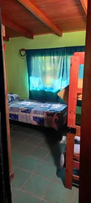 a small bedroom with a bunk bed in a room at Cabañas UN LUGAR in Villa General Belgrano