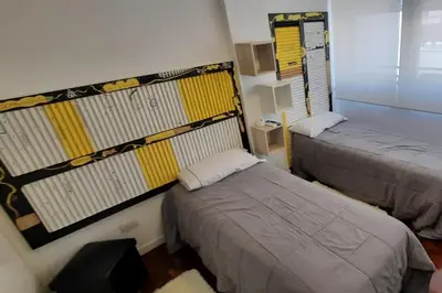 a room with two beds in a room at Departamento Centro Artístico Manzana Jesuítica in Cordoba