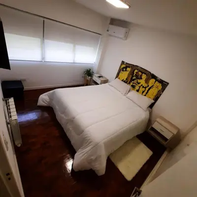a large white bed in a room with a window at Departamento Centro Artístico Manzana Jesuítica in Cordoba