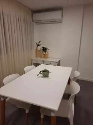 a white table with white chairs and a plant on it at Departamento Centro Artístico Manzana Jesuítica in Cordoba