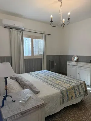 a bedroom with a large bed and a lamp at Elportal in Alta Gracia