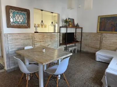 a living room with a wooden table and chairs at Elportal in Alta Gracia