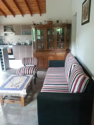 a living room with two couches and a table at La Casita de Onha in Villa Ciudad Parque