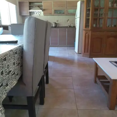 a kitchen with a table and a chair in it at La Casita de Onha in Villa Ciudad Parque