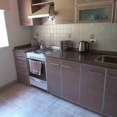 a kitchen with a stove and a sink at La Casita de Onha in Villa Ciudad Parque