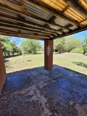 an outside view of a porch with a wooden roof at Casa de campo in Santa María