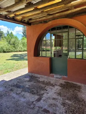 an outside view of a building with an open window at Casa de campo in Santa María