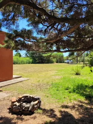 a pile of rocks in a field under a tree at Casa de campo in Santa María