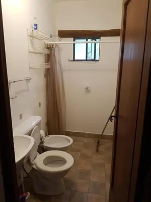 a bathroom with a toilet and a sink at Casa de campo in Santa María