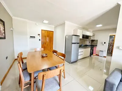 a kitchen and dining room with a wooden table and chairs at Constantino V in Villa Carlos Paz