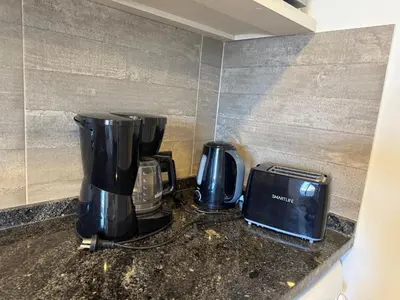 two coffeemakers and a toaster on a counter at Constantino V in Villa Carlos Paz