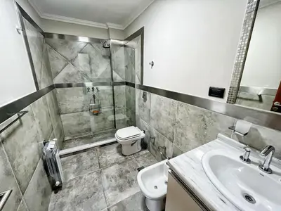 a bathroom with a sink and a toilet and a shower at Constantino V in Villa Carlos Paz