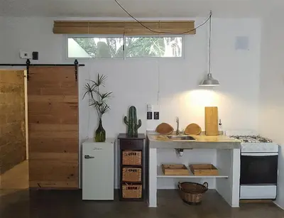 a kitchen with a counter and a sink in a room at Aloja Merlo - Conectá con la naturaleza en un ambiente único in Merlo