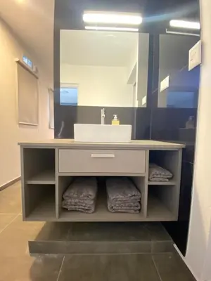 a bathroom with a sink and a mirror at ALEM LANE in Villa Carlos Paz