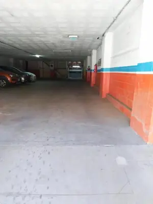 an empty parking garage with a car parked in it at Depto Las Heras in Villa Carlos Paz